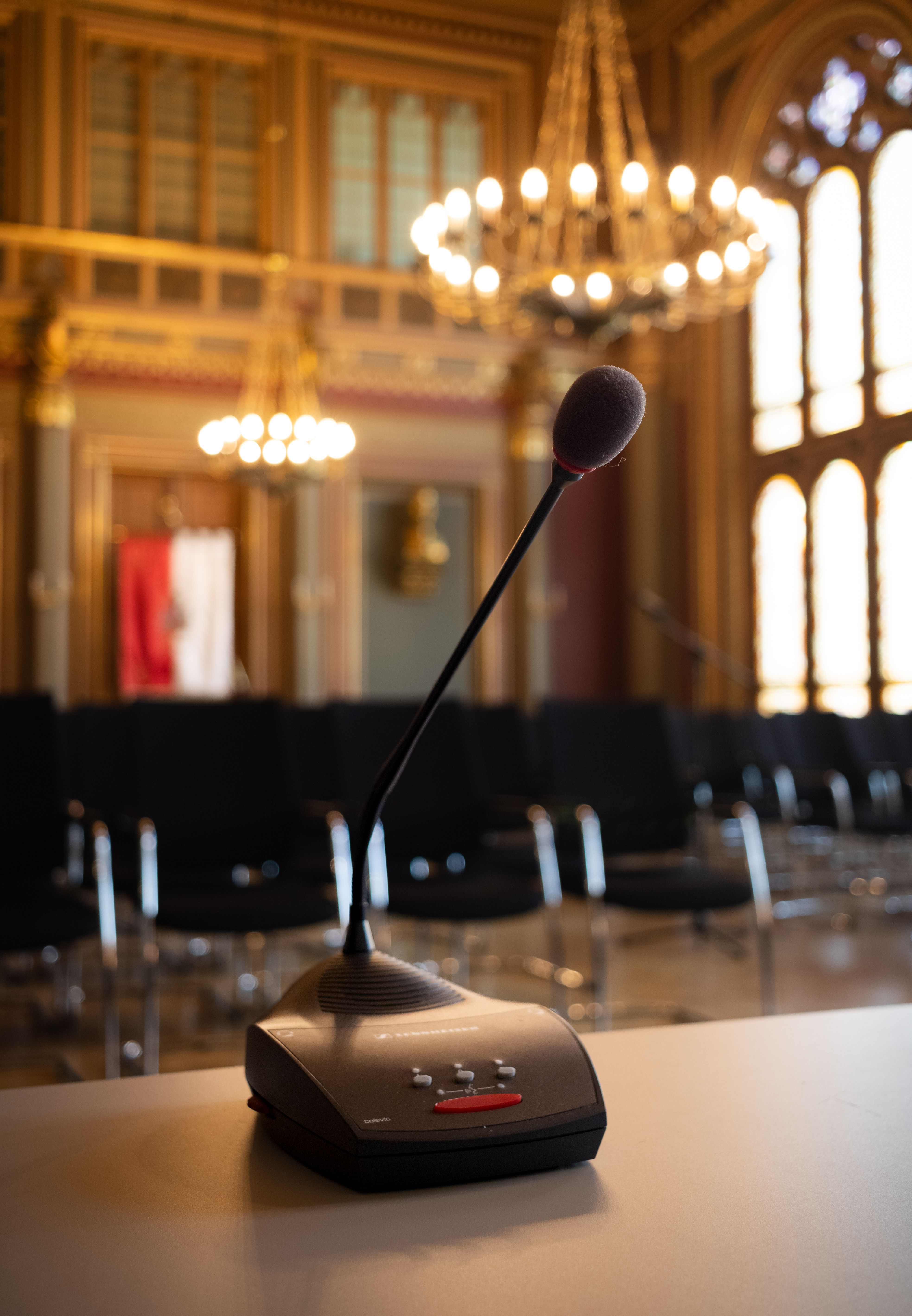 Professional microphone setup on a sleek table inside an upscale event space